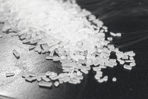 Close-up of 3mm dry ice pellets on a black surface